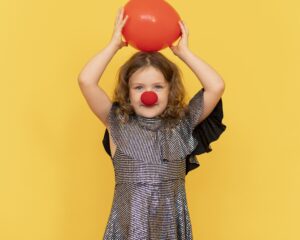 medium shot girl wearing clown nose